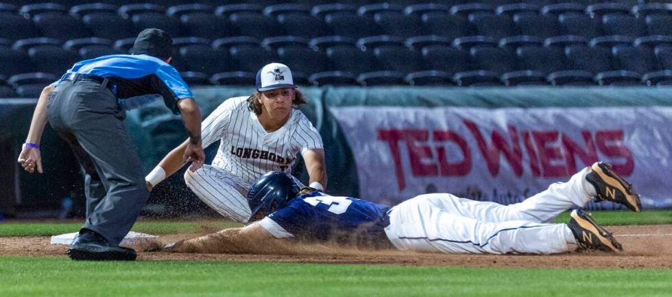 Legacy third baseman Theodore Chartier (8) tags out Shadow Ridge runner Bret Emery (34) after a ...