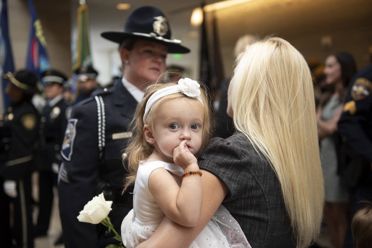 Melody May, center, 1, is held by her mother Joanna May before the start of the Southern Nevada ...