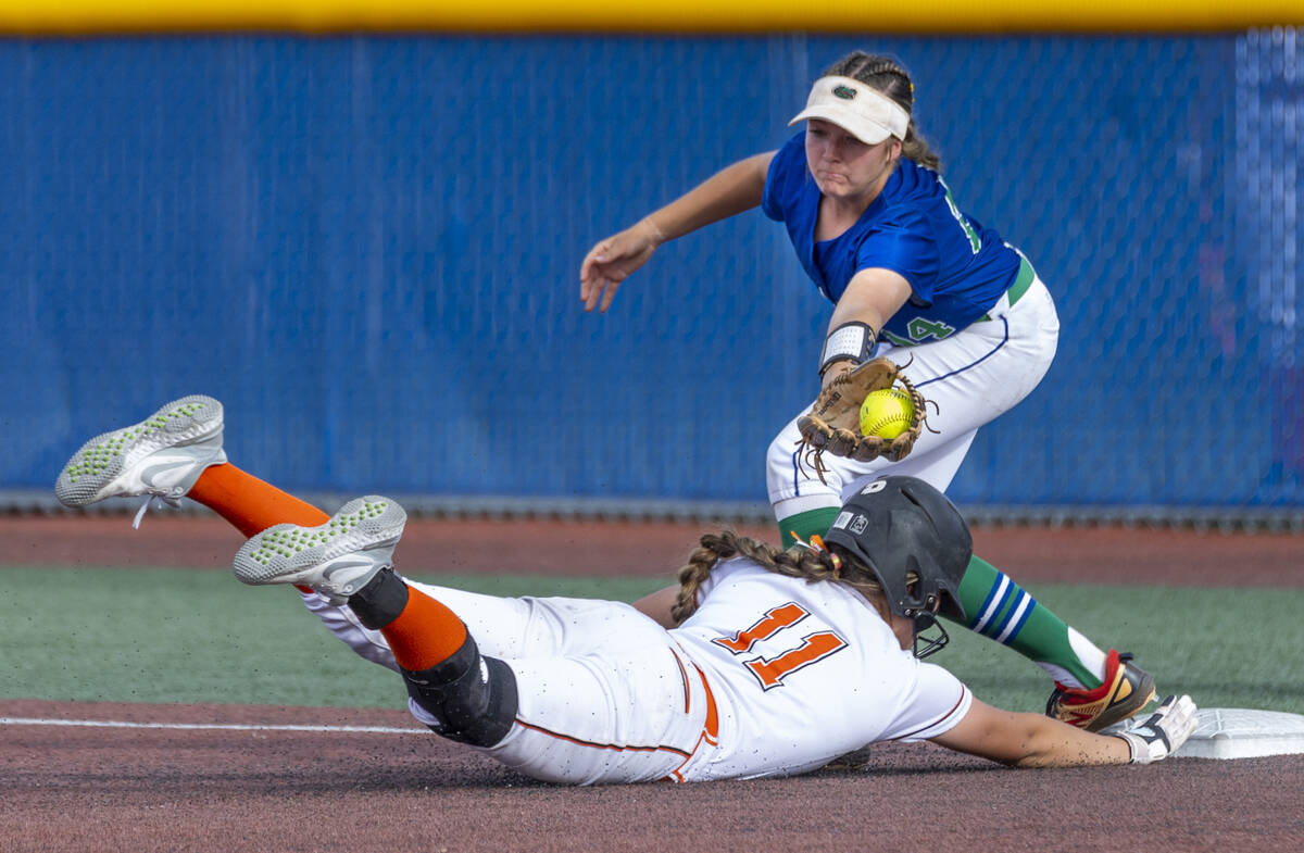 Douglas runner Zora Simpson (11) dives back to first base as Green Valley infielder Rustie Rile ...
