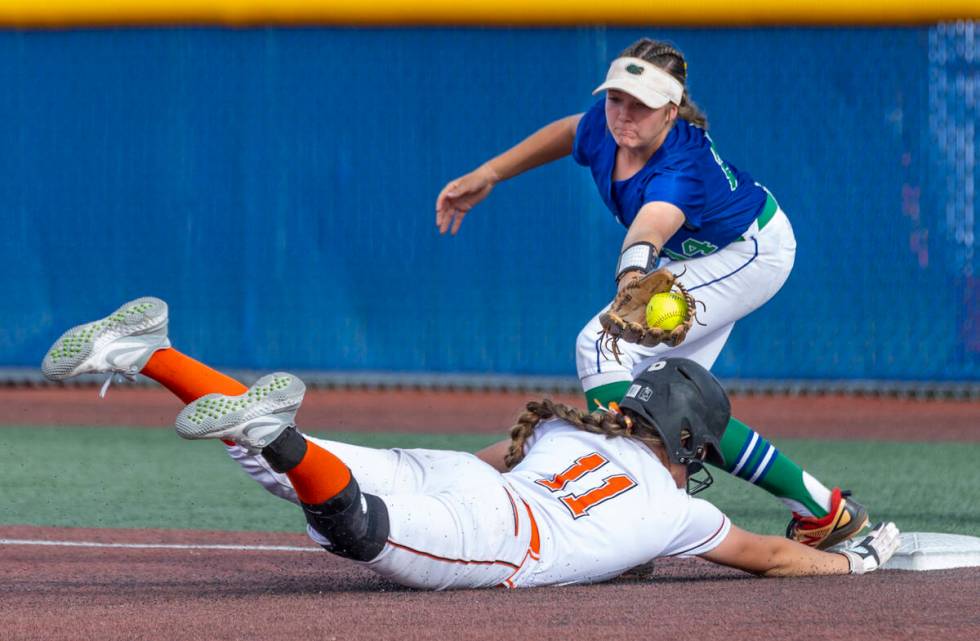 Douglas runner Zora Simpson (11) dives back to first base as Green Valley infielder Rustie Rile ...