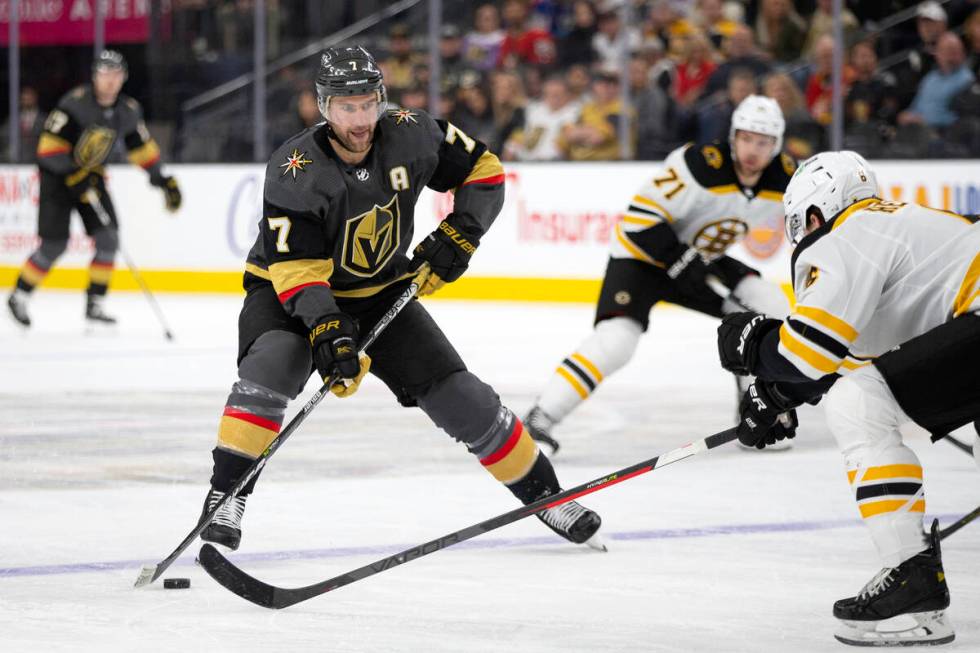 Golden Knights defenseman Alex Pietrangelo (7) skates against Bruins defenseman Mike Reilly (6) ...