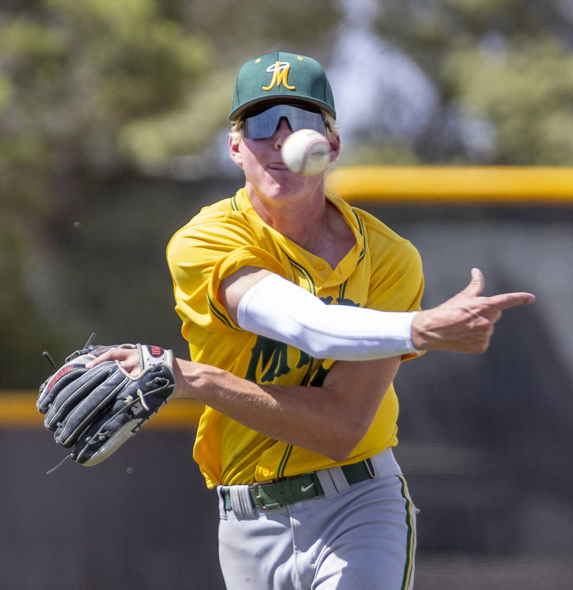 Bishop Manogue short stop Logan Pruski (10) whips a ball to first base and a Basic runner durin ...