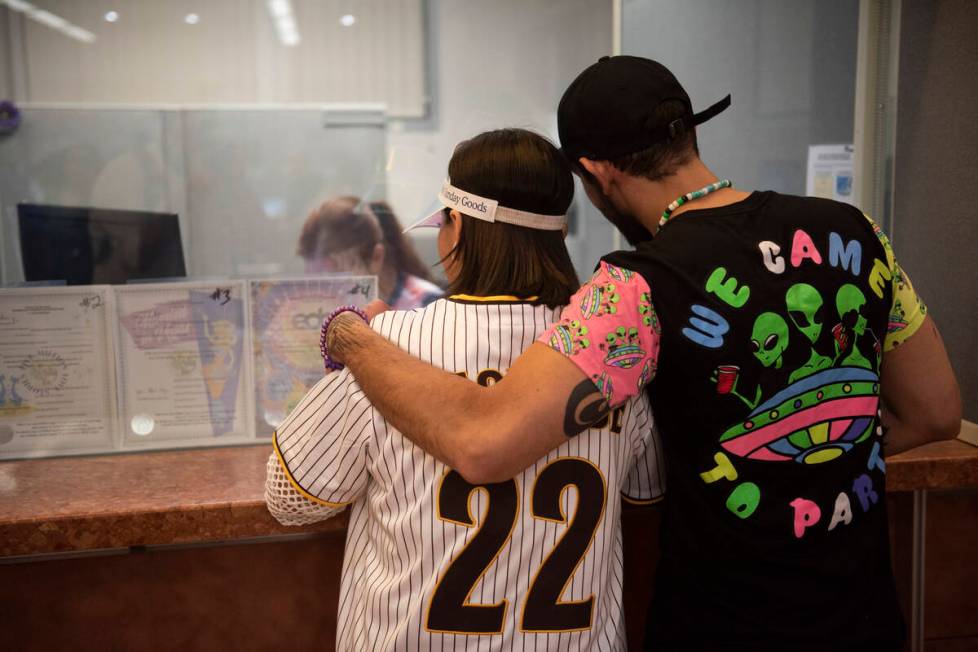 Jessica Avila, left, and Carlos Mendez get their EDC-themed marriage license at the Clark Count ...