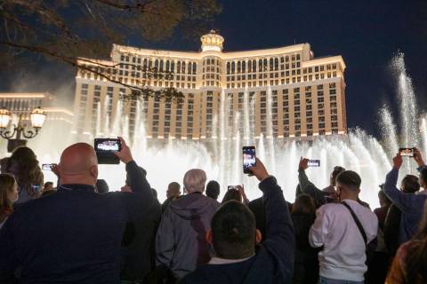 Individuals watch the Bellagio Fountains while celebrating New Years Eve on the Las Vegas Strip ...
