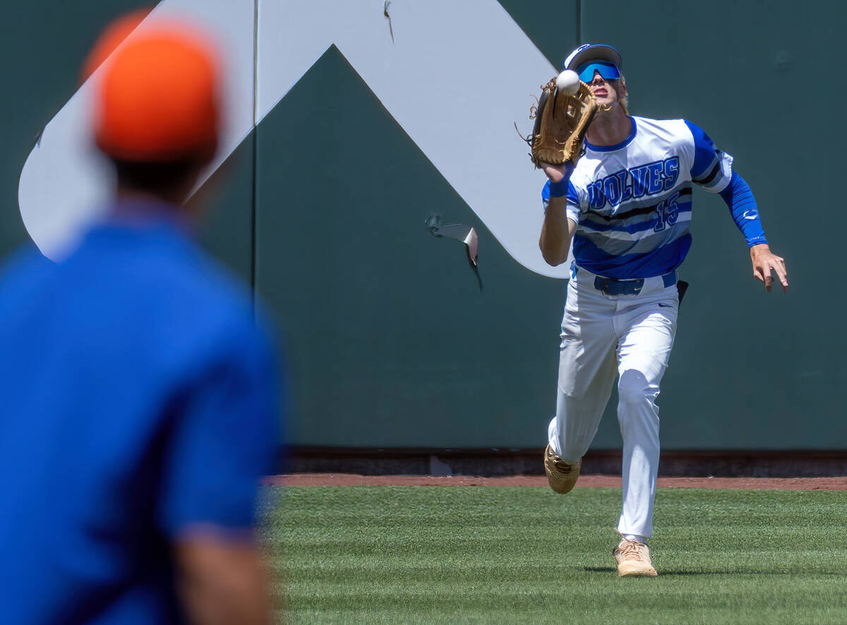 Basic outfielder Colin Hushaw (15) looks in a fly ball for an out from Bishop Gorman during the ...