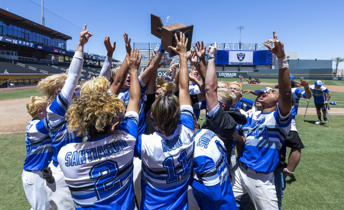 Basic players and coaches celebrate with the trophy after defeating Bishop Gorman 16-7 during t ...