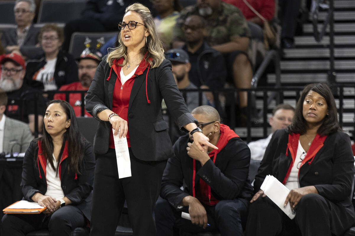 Las Vegas Aces head coach Becky Hammon, front, shouts to her team from the sideline during the ...