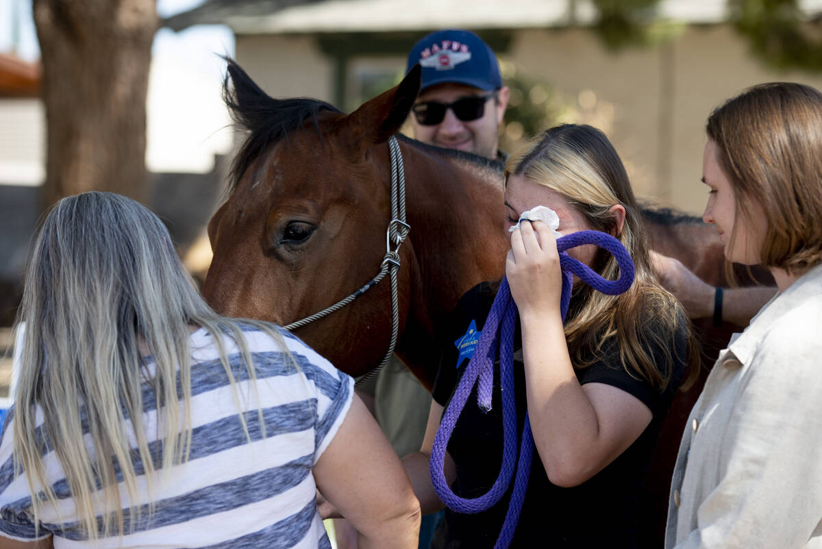 Bailey King, 17, center, cries tears of joy after being gifted her own horse on Saturday, May 2 ...