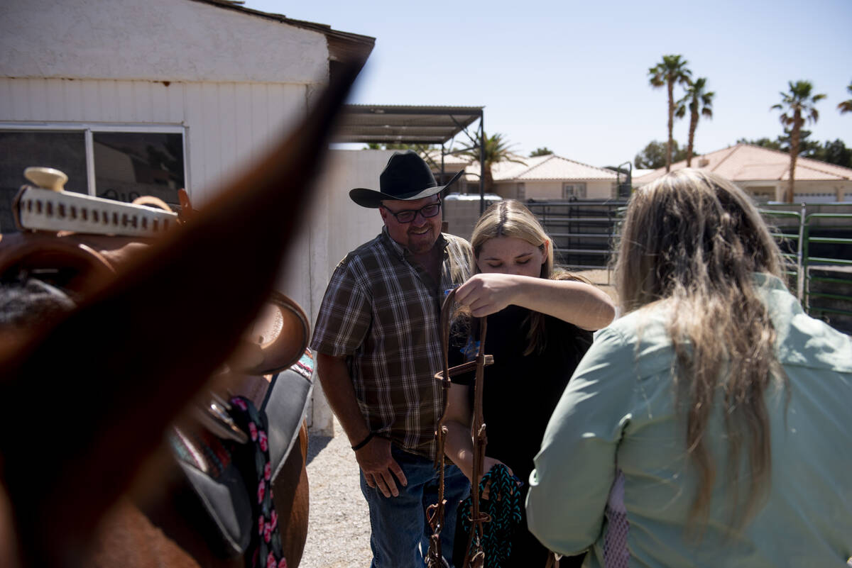 Bailey King, 17, center, helps get her new horse Sierra ready to ride on Saturday, May 21, 2022 ...