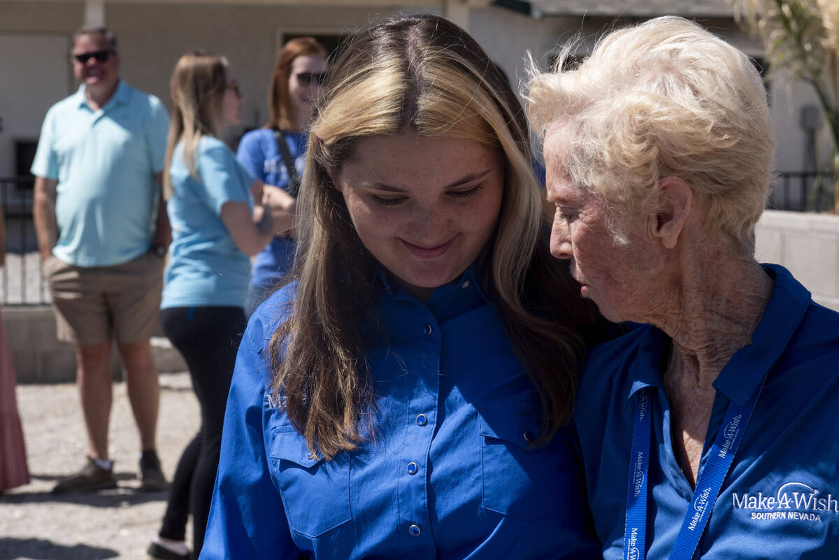Bailey King, 17, left, hugs Make-A-Wish volunteer Betty Evans on Saturday, May 21, 2022, in Las ...