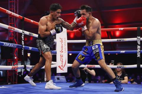 Jessie Magdaleno, left, connects a punch against Edy Valencia Mercado in the fifth round of the ...