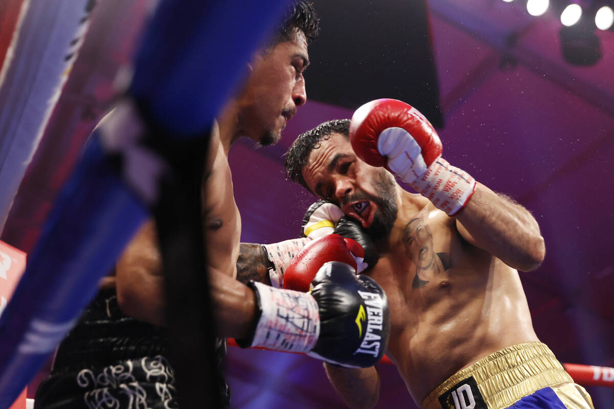 Jessie Magdaleno, left, connects a punch against Edy Valencia Mercado in the eight round of the ...