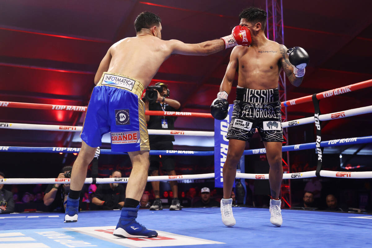 Edy Valencia Mercado, left, connects a punch against Jessie Magdaleno in the eight round of the ...