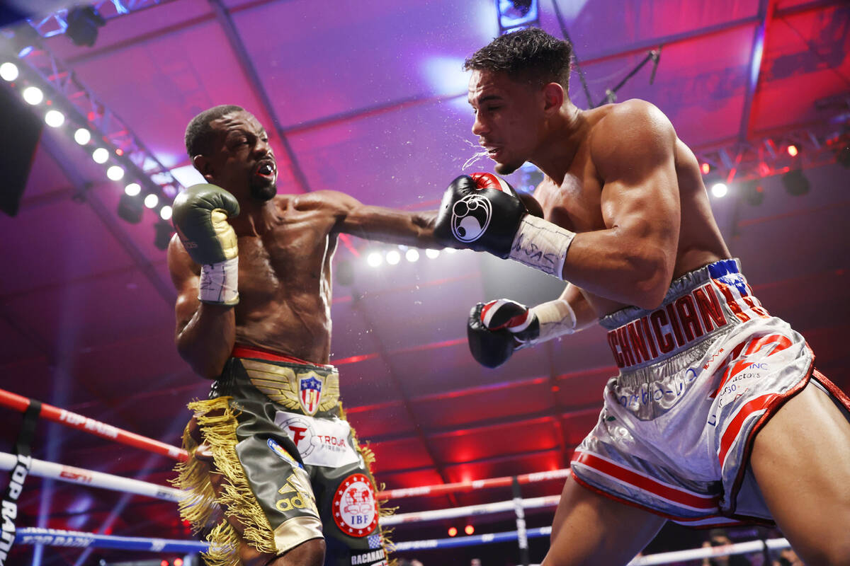 Jamel Herring, left, connects a punch against Jamaine Ortiz in the 10th round of a lightweight ...