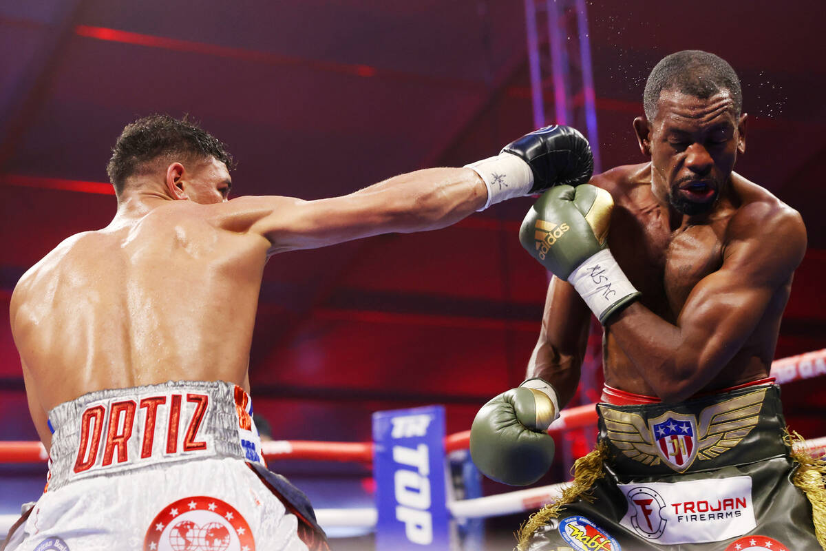 Jamaine Ortiz, left, throws a punch against Jamel Herring in the seventh round of a lightweigh ...