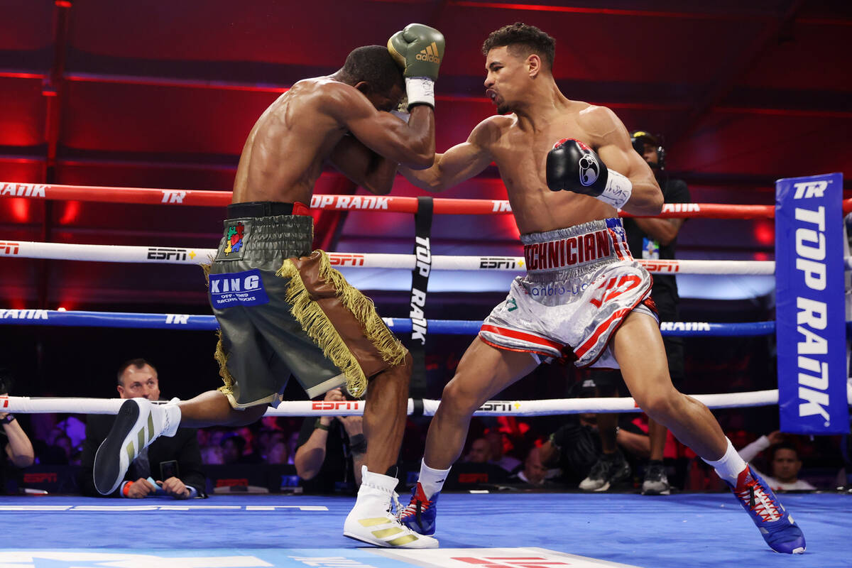 Jamaine Ortiz, right, throws a punch against Jamel Herring in the third round of a lightweight ...