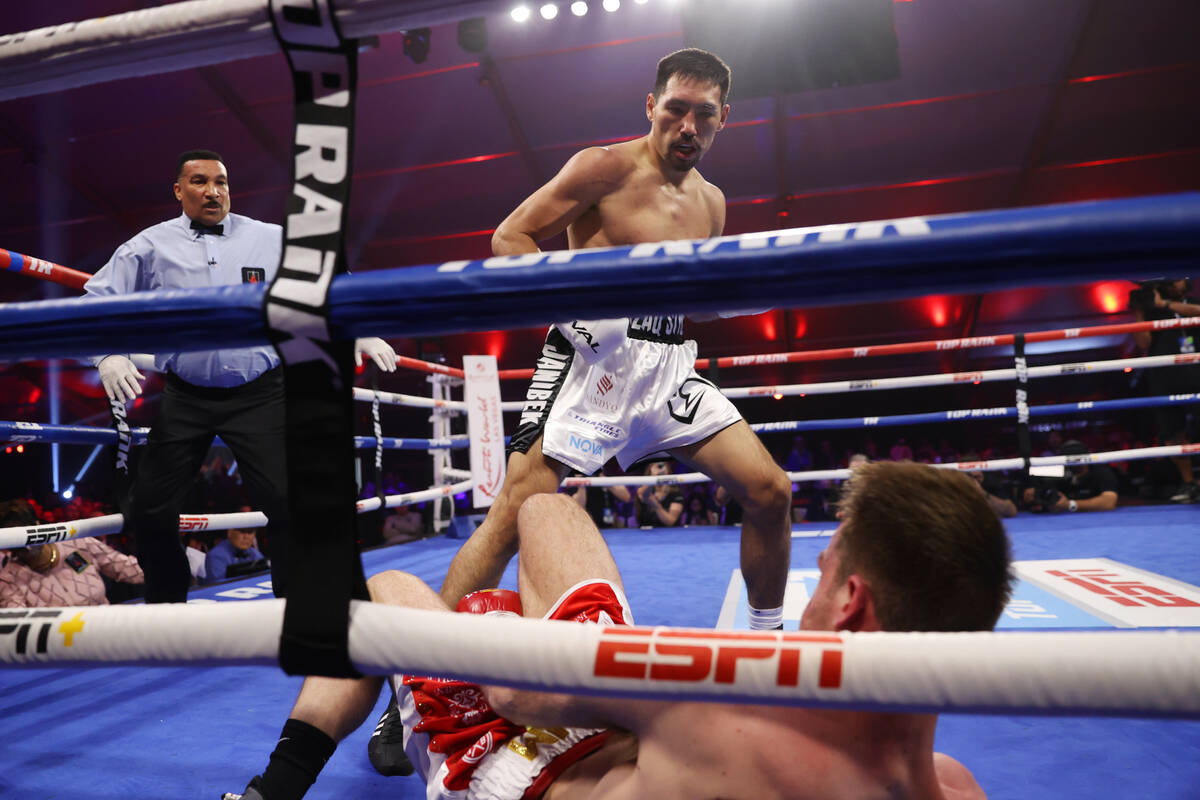 Janibek Alimkhanuly, top, knocks out Danny Dignum in the second round of the WBO middleweight t ...