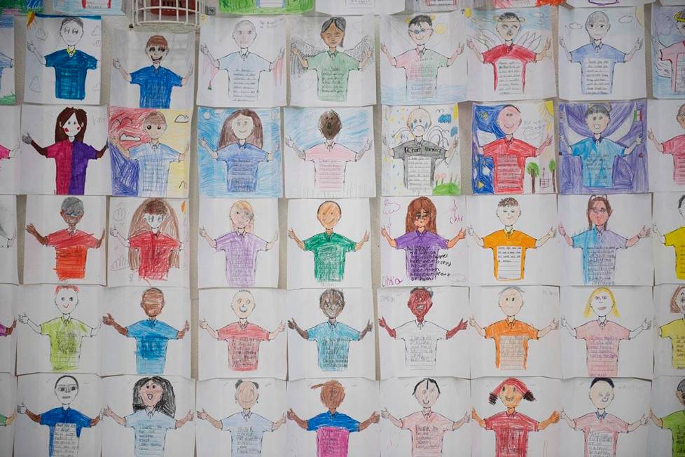 Cards drawn by students hang on the wall at Reynaldo Martinez Elementary School to honor its na ...