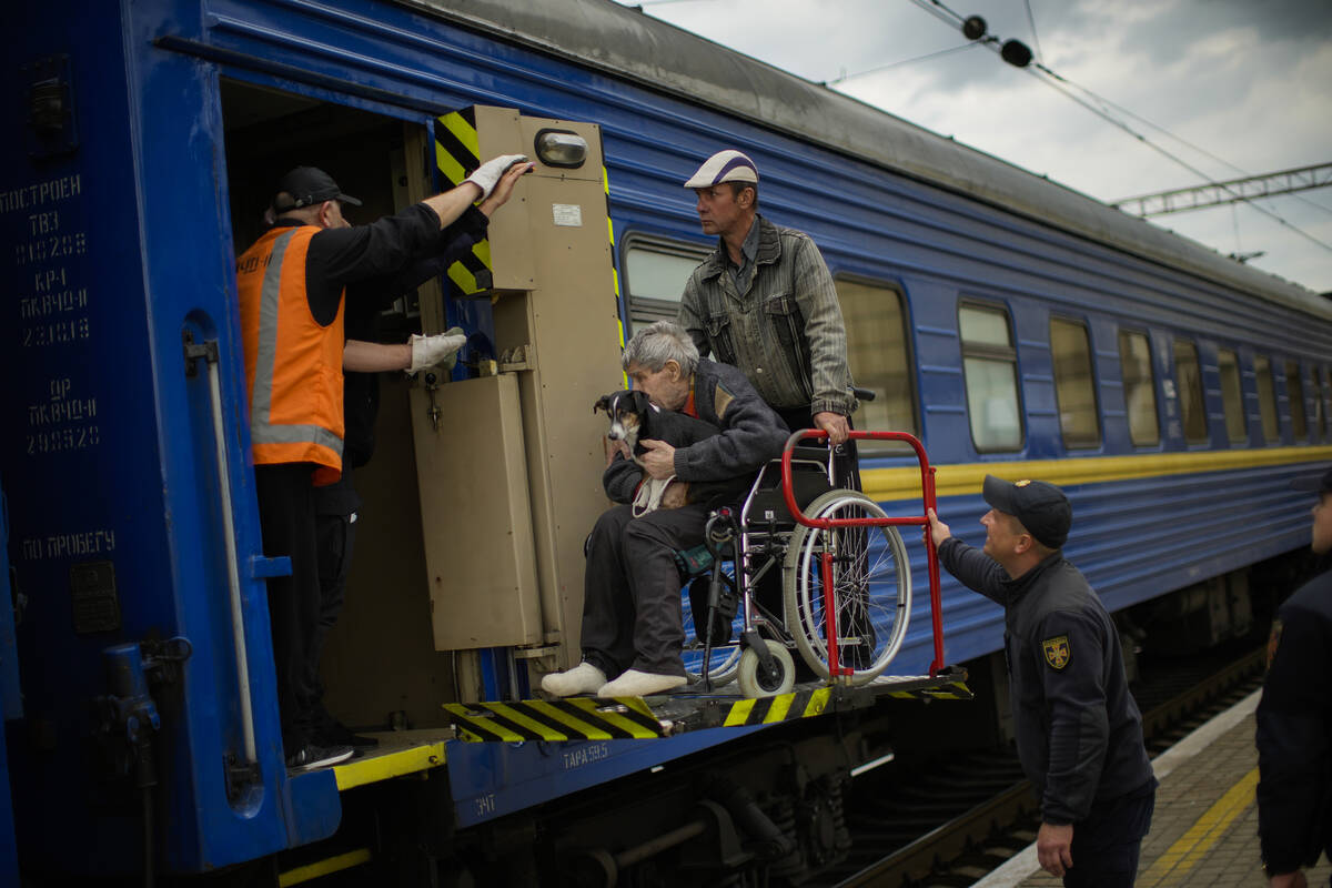 People fleeing from shelling board an evacuation train at the train station, in Pokrovsk, east ...