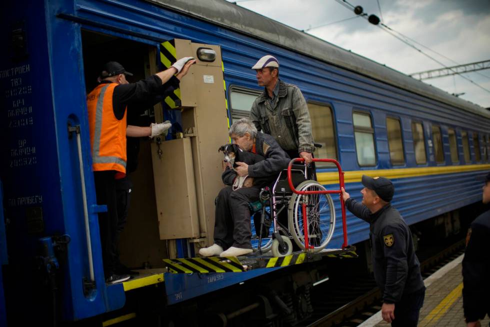 People fleeing from shelling board an evacuation train at the train station, in Pokrovsk, east ...