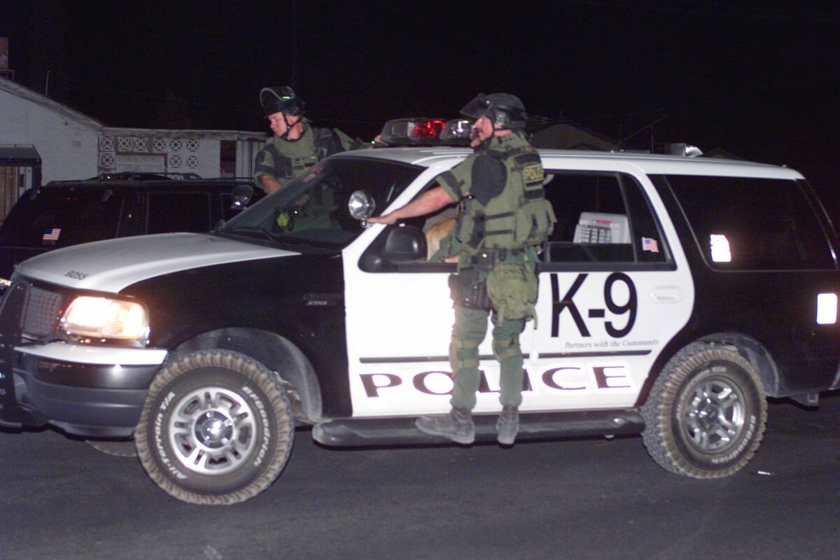 SWAT officers ride down Bonanza Road on Sunday, April 14, 2002, in search of Timmy "T.J." Weber ...