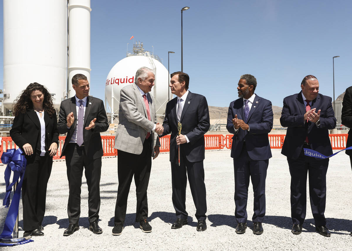 Gov. Steve Sisolak, third from left, shakes hands with Mike Graff, executive vice president of ...