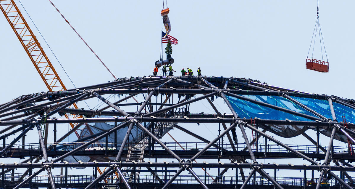 Construction crews bring up to place the last piece of steel beam atop the MSG Sphere at The Ve ...