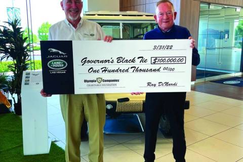 Ray Dinardi, left, general manager of Jaguar Land Rover Las Vegas, presents a donation for $100 ...