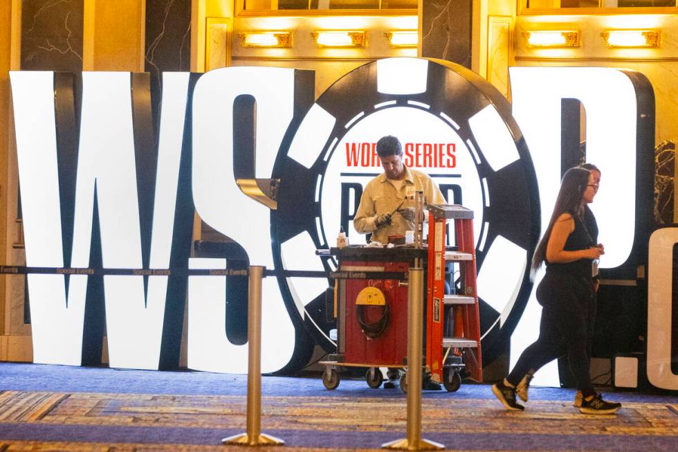 David Hemby, a carpenter, installs the World Series of Poker tournament sign at Paris Las Vegas ...