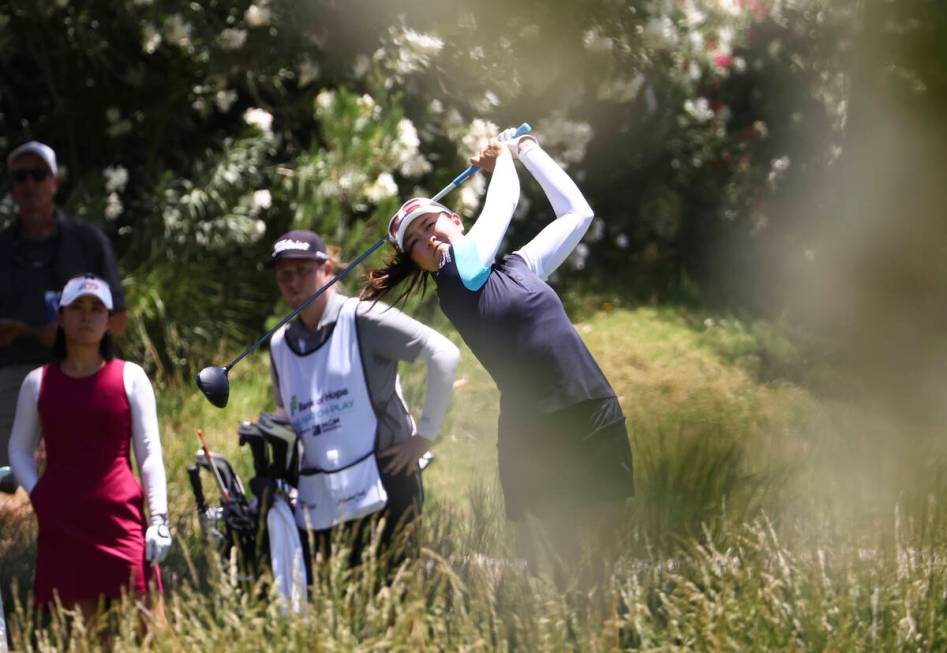 Kelly Tan tees off at the 12th hole while playing against Danielle Kang, left, in the first rou ...