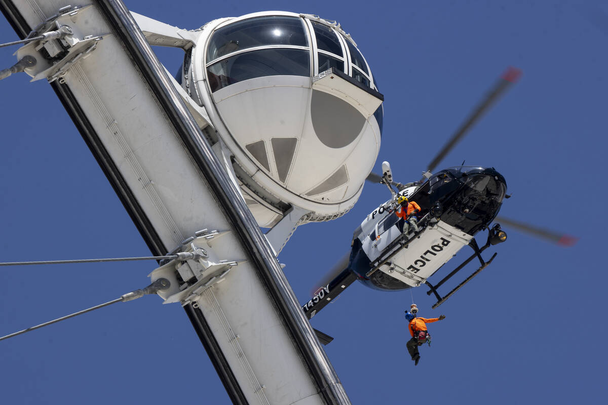 With one of the High Roller cabins just feet away, a Metro police helicopter hovers. The Las Ve ...