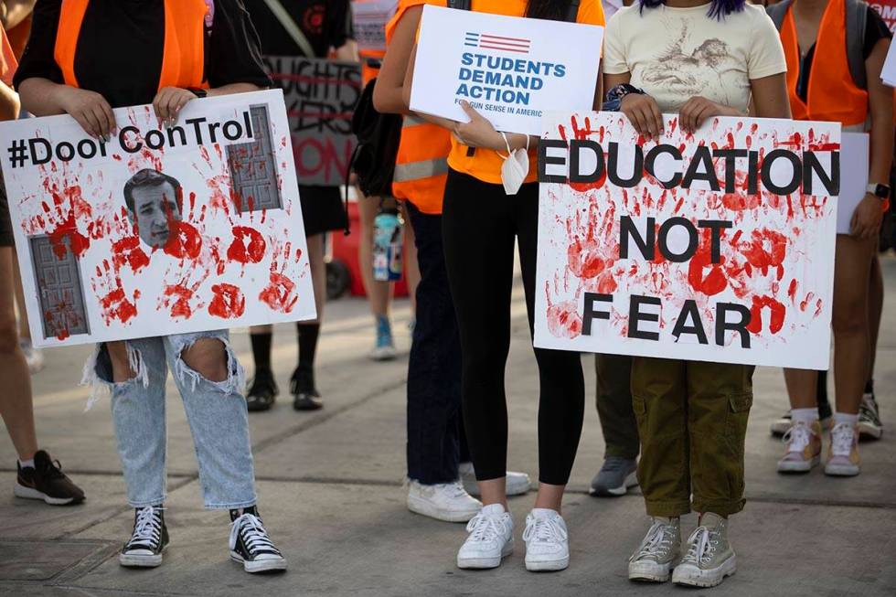 People participate during a rally and march by Moms Demand Action and Clark County School Distr ...