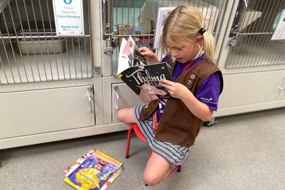 A member of Brownies Troop 29 in Henderson reads to sheltered animals at The Animal Foundation ...