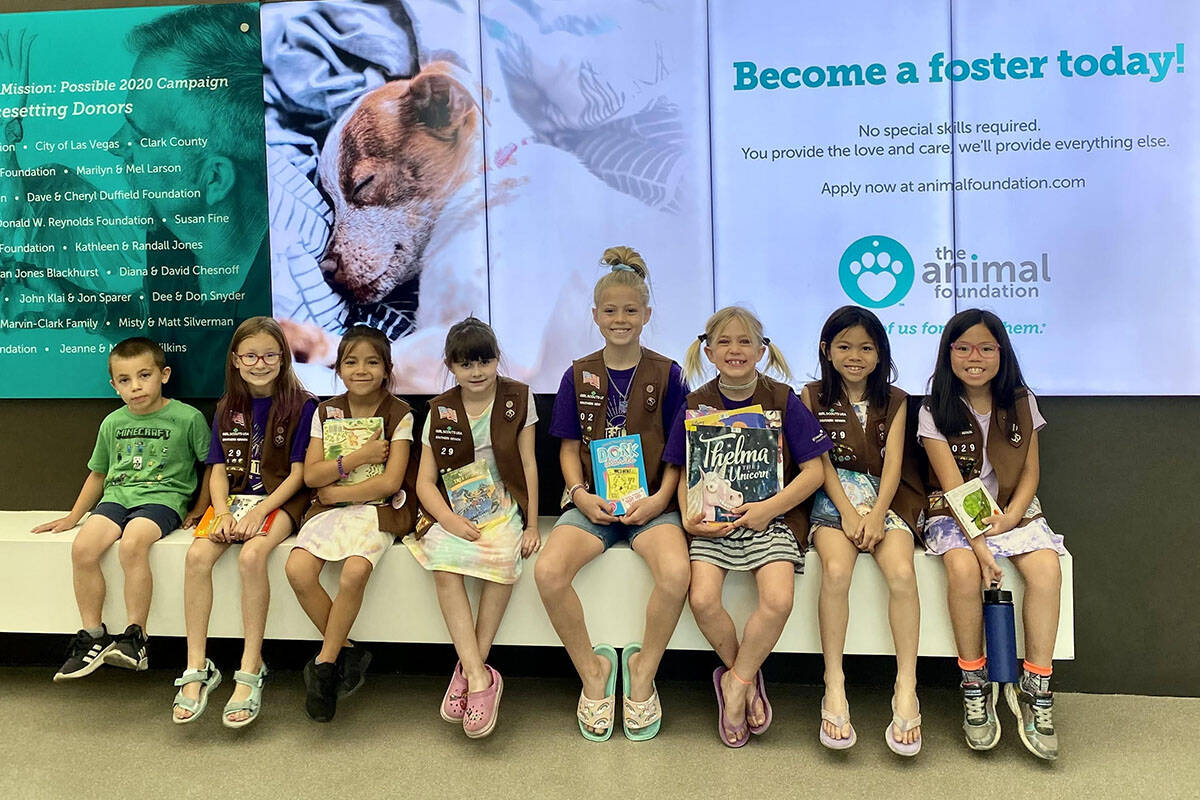 Brownies Troop 29 in Henderson read to sheltered animals at The Animal Foundation on Thursday, ...