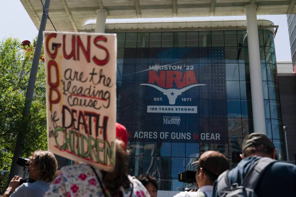 People gather outside the George R. Brown Convention Center to protest the National Rifle Assoc ...