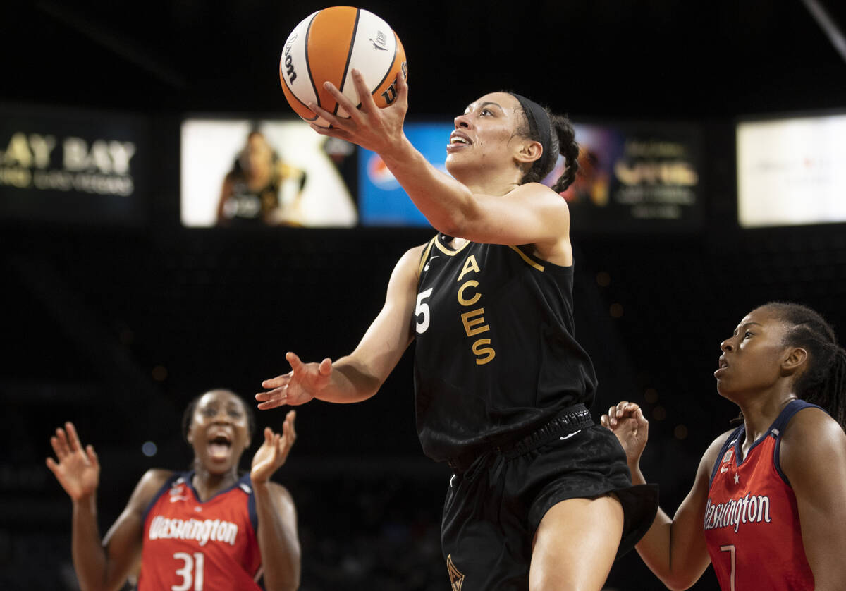 In this Aug. 15, 2021, file photo, Las Vegas Aces forward Dearica Hamby (5) drives past Washing ...