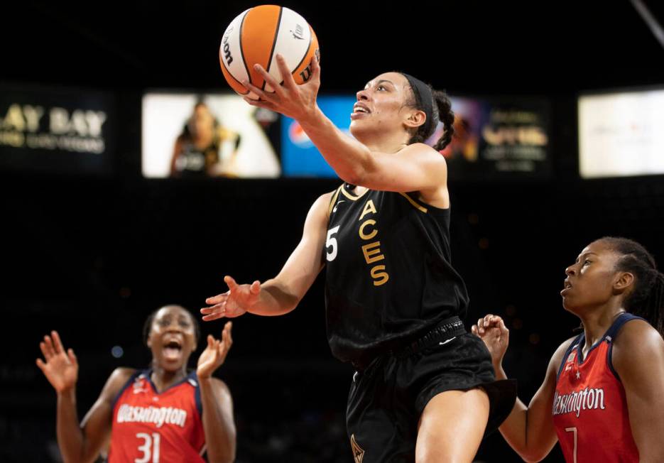 In this Aug. 15, 2021, file photo, Las Vegas Aces forward Dearica Hamby (5) drives past Washing ...