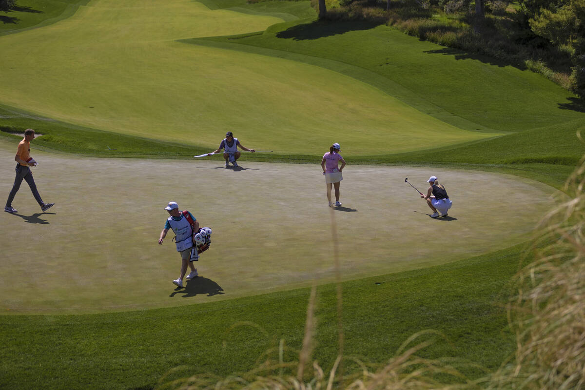 Jodi Ewart Shadoff, right, and Ayake Furue read the green on the 5th hole during the fourth day ...