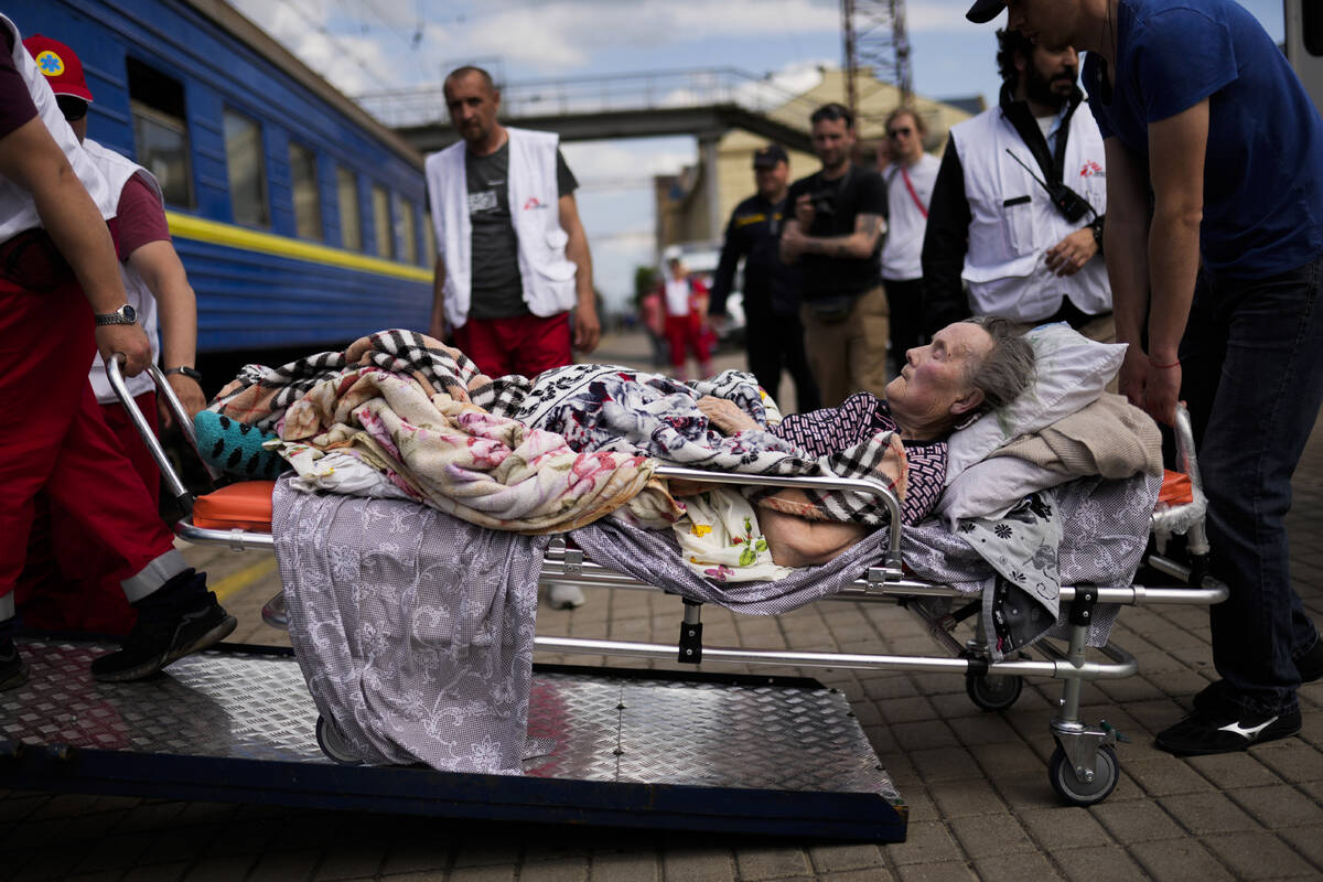 An elderly patient boards a medical evacuation train run by MSF (Doctors Without Borders) at th ...
