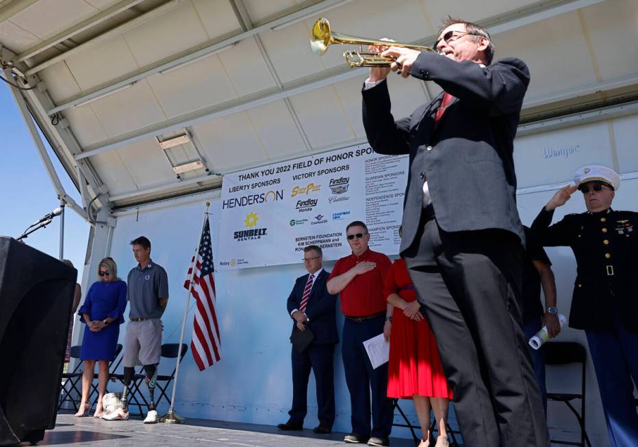 Lance Phelps plays Taps, Monday, May 30, 2022, at Cornerstone Park in Henderson, during the 202 ...