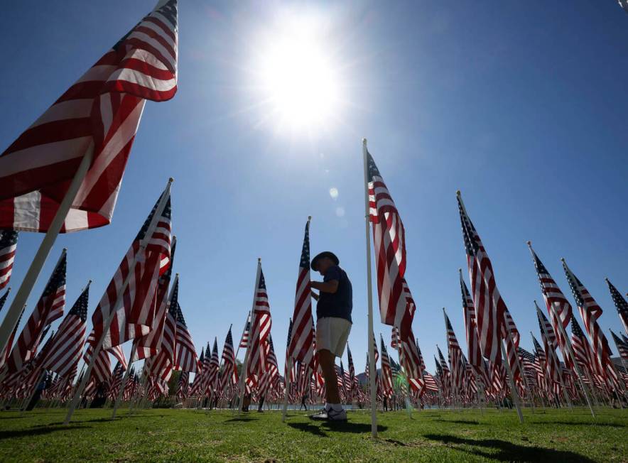 Dr. Marin Wilner of Henderson walks through American flags, Monday, May 30, 2022, at Cornerston ...