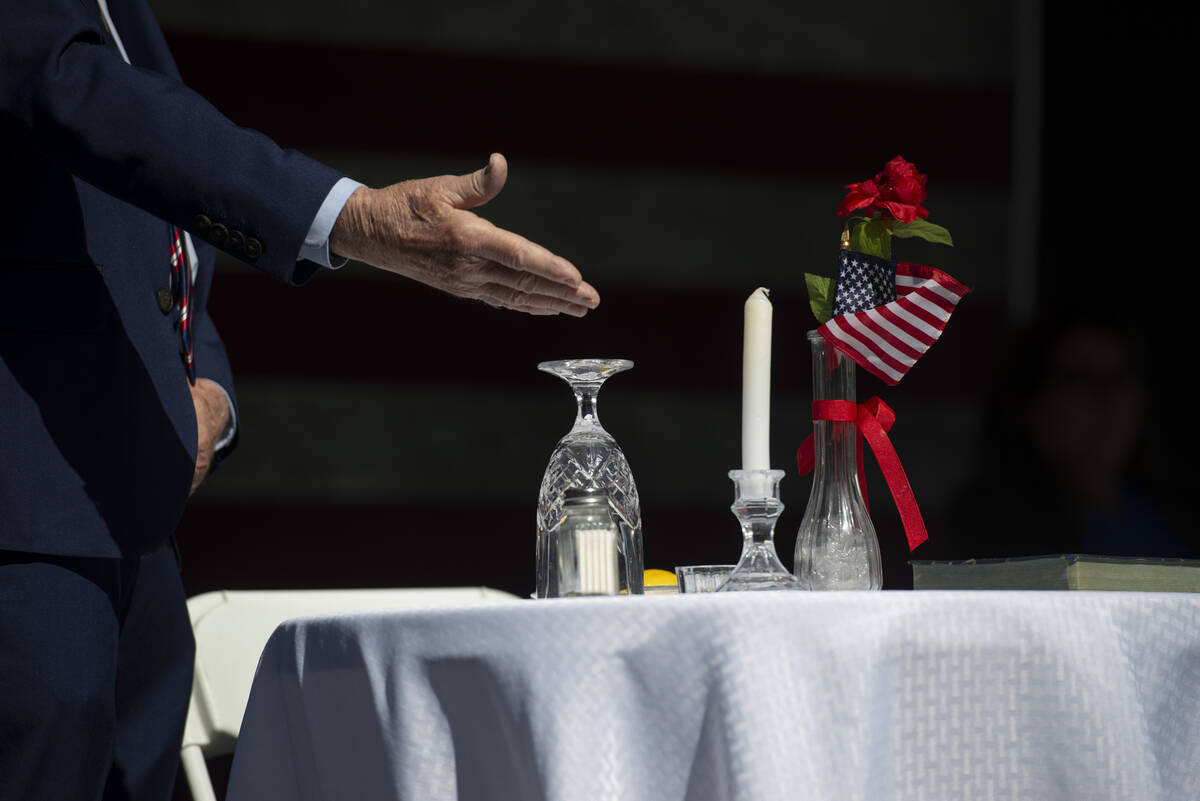Donald Freund points to the items on the table during the POW/MIA table ceremony at Lake Sahara ...