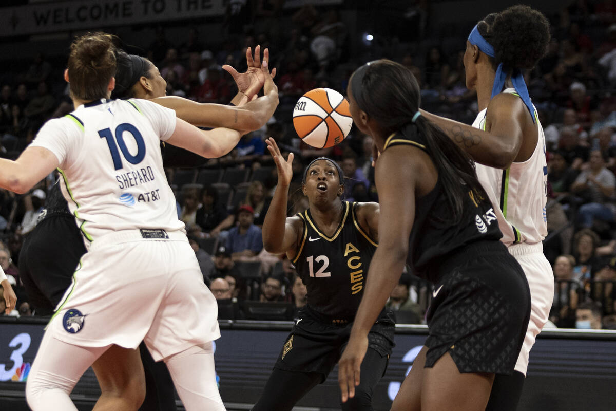 Las Vegas Aces guard Chelsea Gray (12) receives a pass while forward A'ja Wilson (22) guards Mi ...