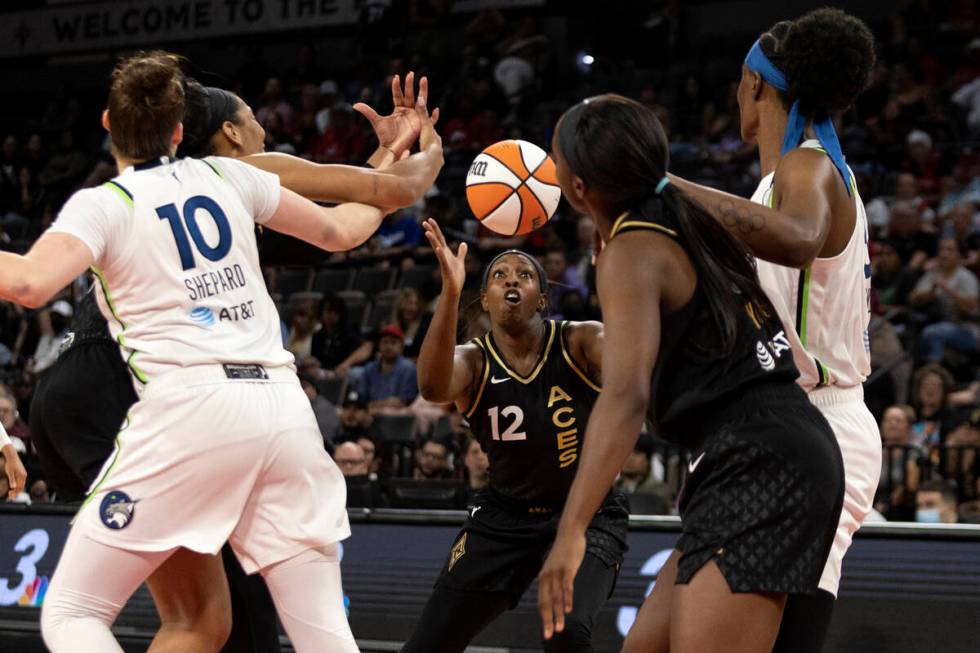 Las Vegas Aces guard Chelsea Gray (12) receives a pass while forward A'ja Wilson (22) guards Mi ...