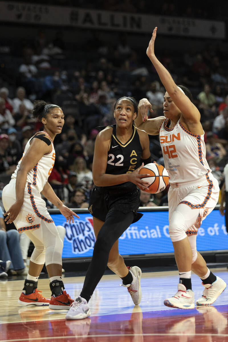 Las Vegas Aces forward A'ja Wilson (22) shoots against Connecticut Sun center Brionna Jones (42 ...