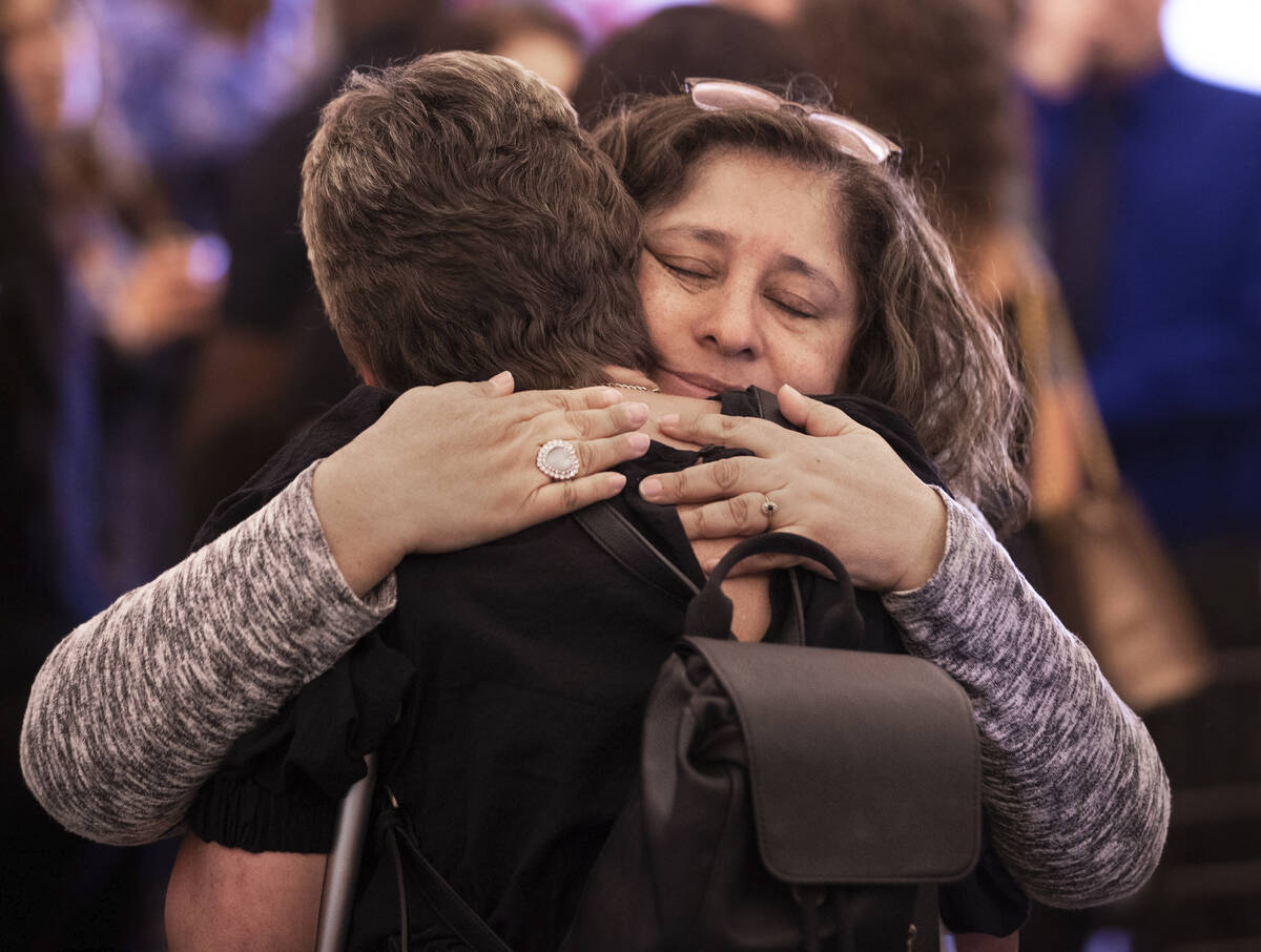 Alicia Jimenez, life partner of Elwood Hensey, is consoled by friends and family during a funer ...