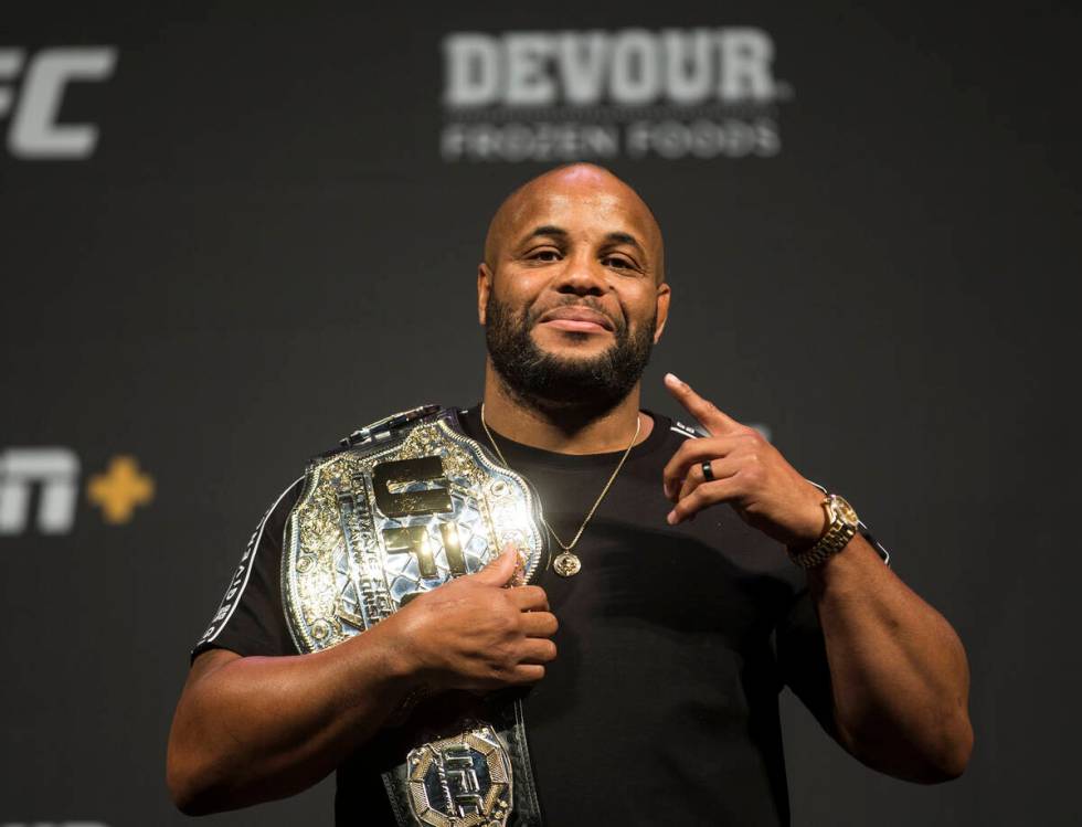 UFC heavyweight champion Daniel Cormier holds his belt during a press conference on Friday, Jul ...