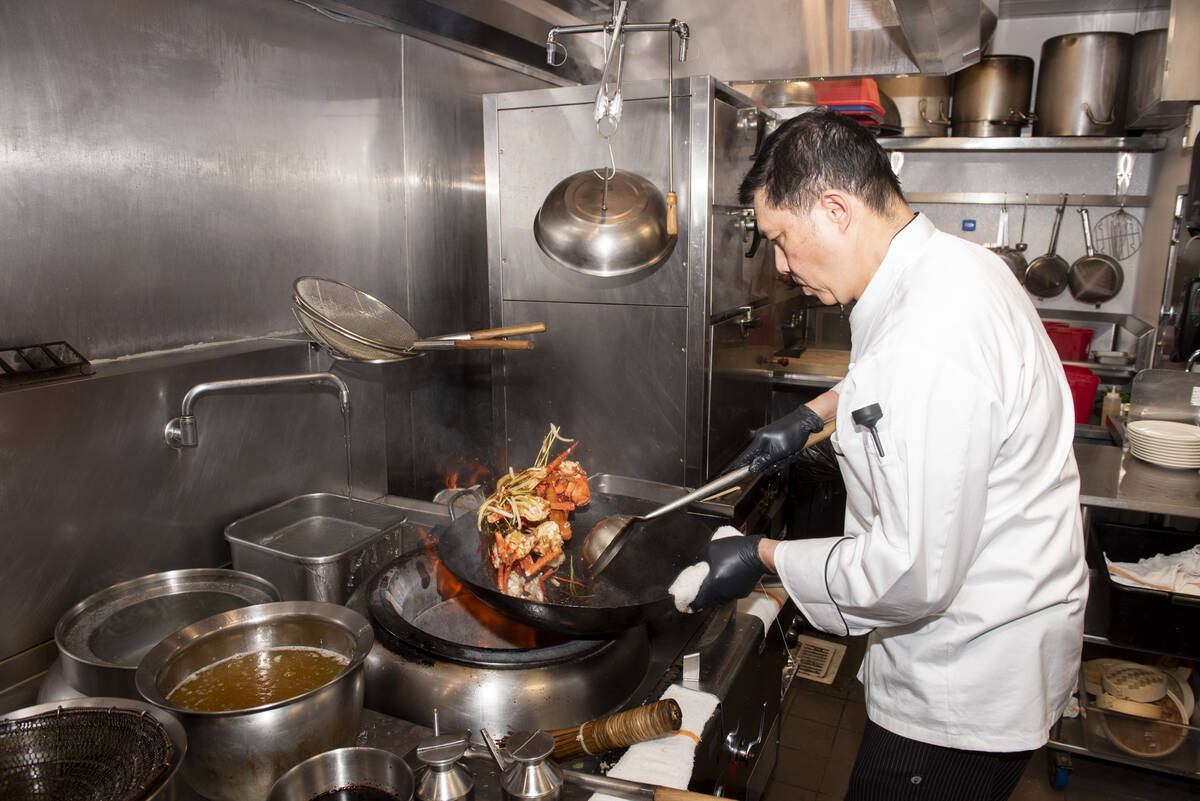 Chef Yip Cheung prepares the Stir-Fried Lobster with Lemongrass and Thai Sauce at Red Plate, a ...