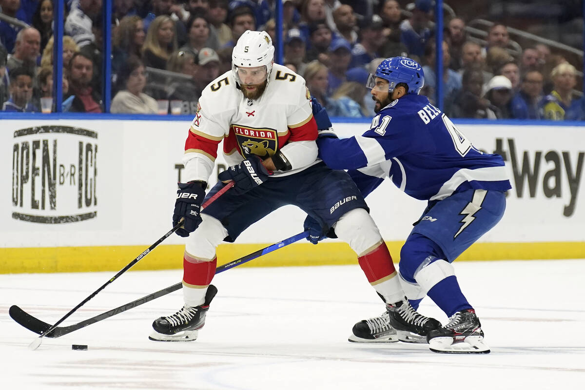 Florida Panthers defenseman Aaron Ekblad (5) gets hit by Tampa Bay Lightning left wing Pierre-E ...