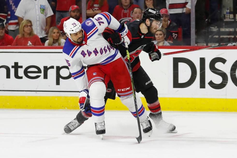 New York Rangers' Ryan Reaves (75) tangles with Carolina Hurricanes' Brett Pesce (22) during th ...